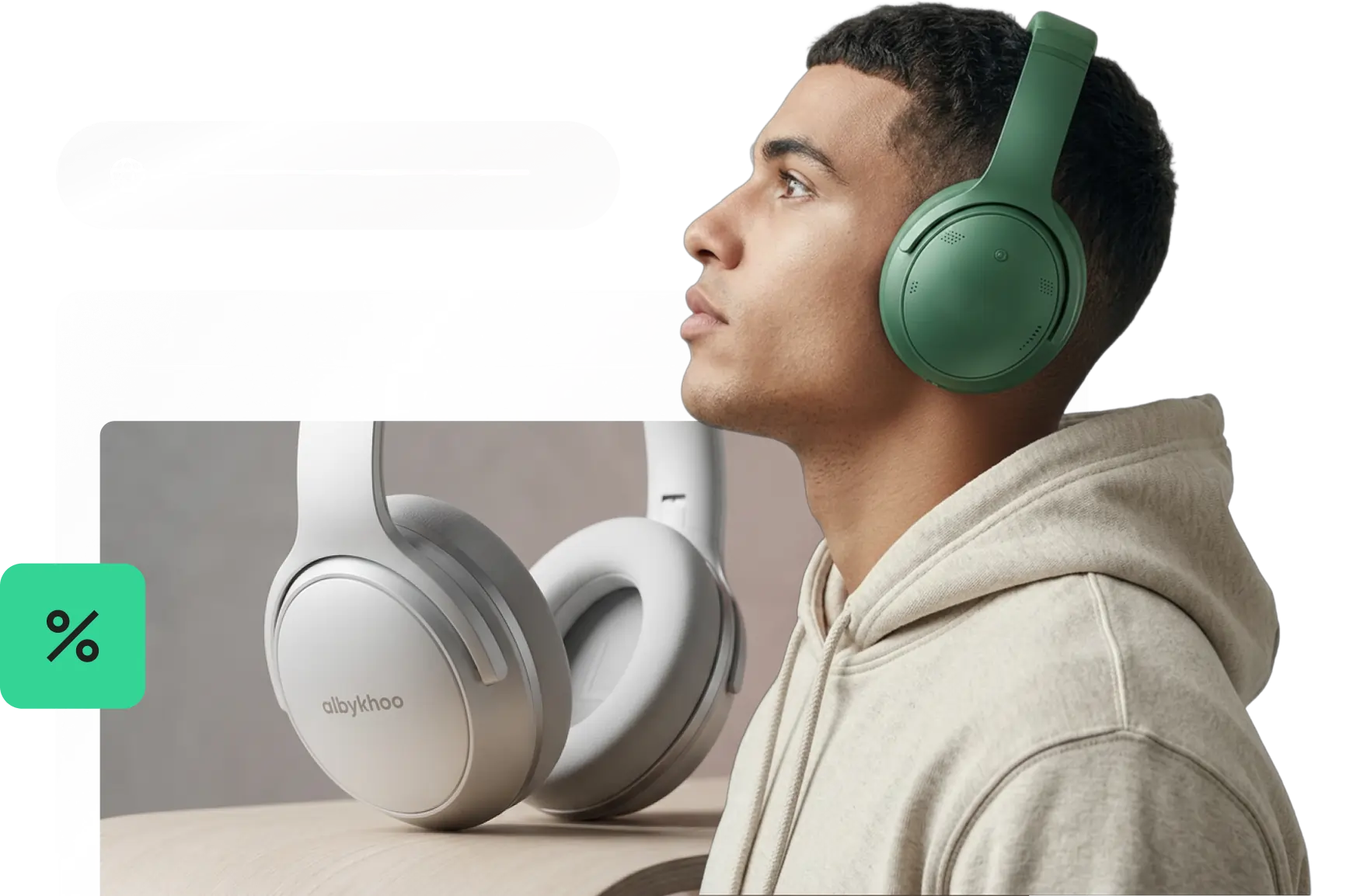 Person wearing green headphones looking up, next to white headphones on a desk, representing a free domain offer with SiteGround hosting plans.